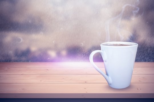 Composite image of cup of coffee on table 