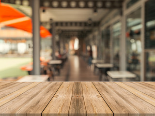 Wooden board empty table in front of blurred background. Perspective brown wood over blur in coffee shop - can be used for display or montage your products.Mock up for display of product.