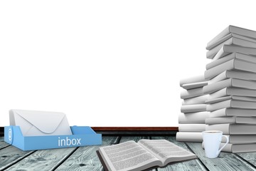 An inbox beside books