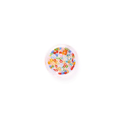 Beads in round box over white isolated background