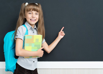 Back to school concept - schoolgirl with backpack