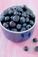 blueberry on wooden surface