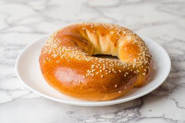 Bagels in white plate on marble background