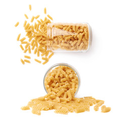 Set of glass jar filled with dry rotini pasta over isolated white background