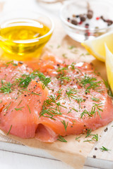 salted salmon with dill on a wooden board, close-up