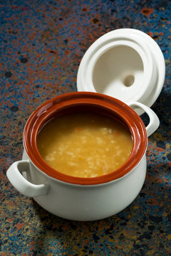 pot of lentil soup on a dark background, top view vertical