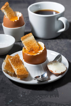 soft boiled egg, toasts and coffee for breakfast 