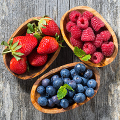 wooden bowls with fresh berries, top view
