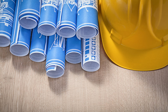 Blue Construction Drawings Building Helmet On Wooden Board