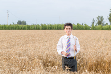 Cute boy in a golden wheat field