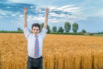 cute caucasian boy in a wheat field