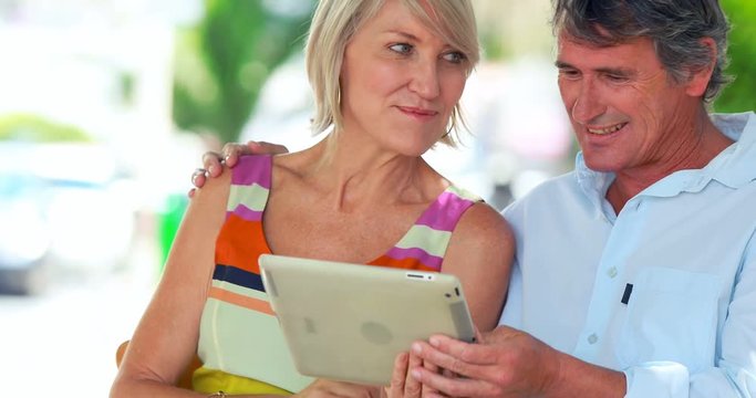 Smiling couple using a tablet
