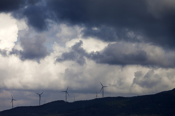 Wind farm and cloudy sky before storm