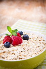 Oatmeal porridge with berries. Raspberries and blueberries.