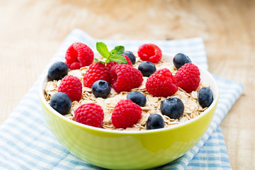 Oatmeal porridge with berries. Raspberries and blueberries.