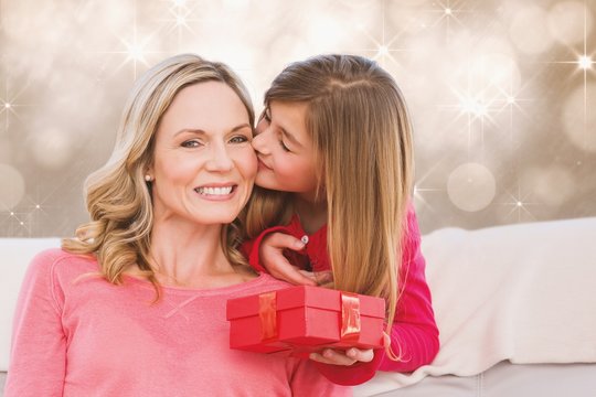 Composite image of smiling mother being kissing by daughter