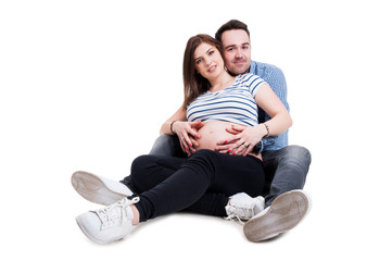 Happy family with young couple of husband and pregnant wife