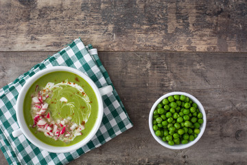 cream peas with radishes on wood