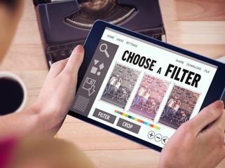 Composite image of woman using tablet pc