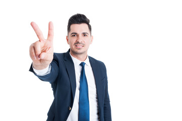 Salesman showing number two peace or victory gesture