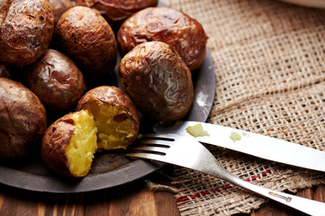 Baked potatoes on a wooden table