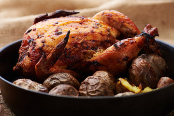 Whole roasted chicken with potatoes