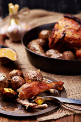 Barbecued chicken leg with baked potatoes