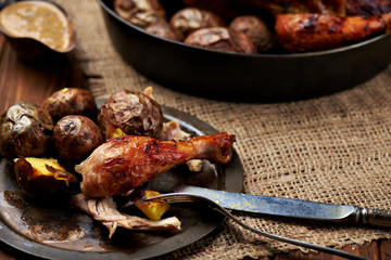 Barbecued chicken leg with baked potatoes