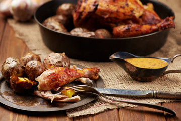 Barbecued chicken leg with baked potatoes