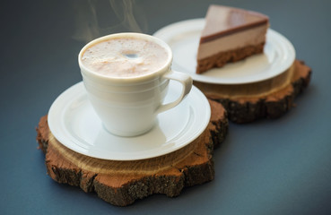 Cup with coffee on the wooden background. Breakfast concept and idea