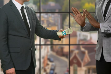 Afro businessman refuses money. Men's bribery on urban background. My word doesn't sell. Honesty...