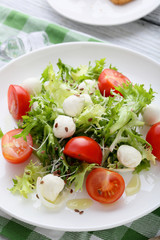 fresh salad with tomatoes on white plate