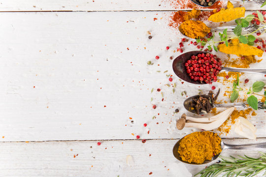 Various colorful spices on wooden table