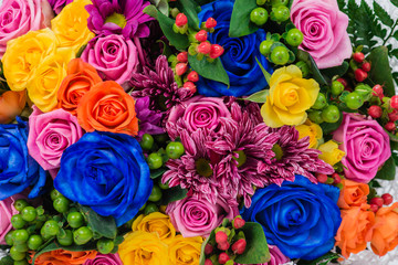 Fototapeta na wymiar close-up of a blue rose, chrysanthemum and shrub rose in a bouqu