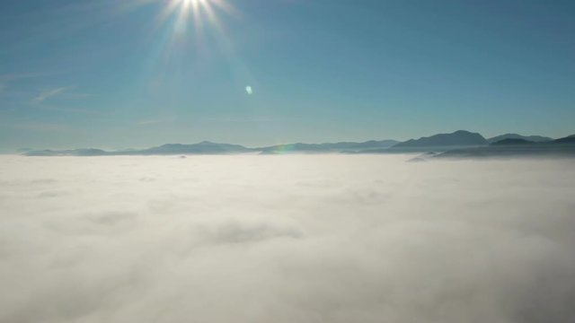Aerial rear view, of clouds and distance landscape.
