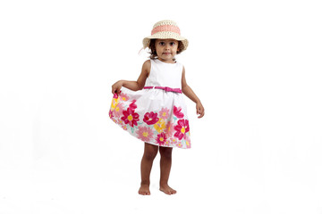 Girl wearing a summer dress and a hat isolated on white background