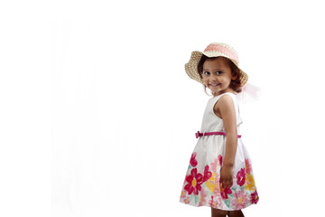 Girl wearing a summer dress and a hat isolated on white background