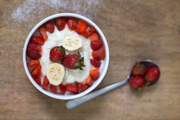milk rice porridge with fruit strawberry and banana breakfast snack