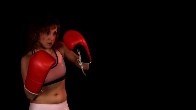 Sexy healthy women boxing in studio on the black background