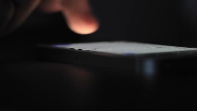 Mobile Phone on Table Pushed and Swiped by Finger.