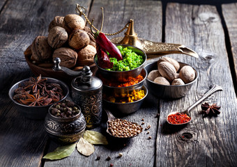 Spices and nuts at wooden table