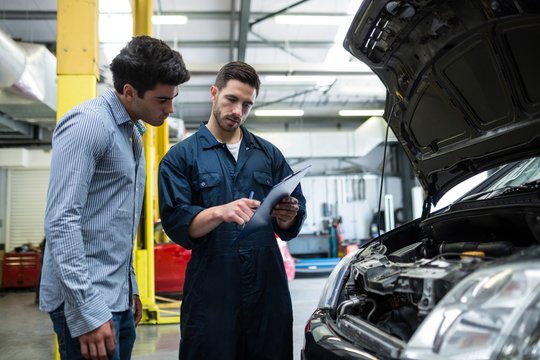 Mechanic showing the quotation to a customer