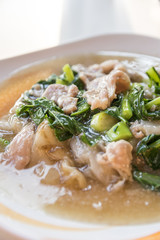 Fried noodle with pork and kale soaked in gravy