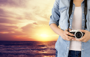 traveler photographer girl taking picture on vintage camera, traveling holiday photography concept, [blur and select focus background]