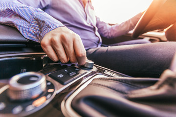 Close-up of a male hand  in a modern car