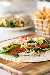shredded barbecued chicken wraps with carrot, cheese, avocado an