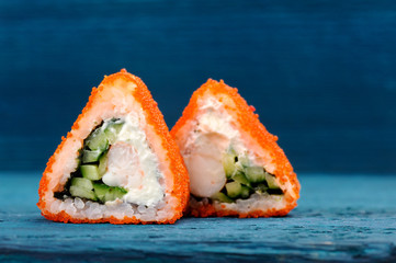 Triangular fusion rolls with orange tobiko roe, cream cheese