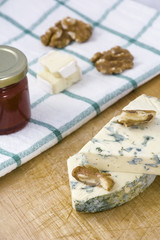 Cheese roquefort with nuts and jam on the towel