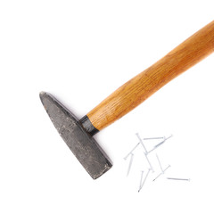 Big hammer with pile of nails over white isolated background
