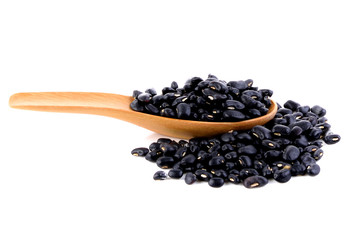 Black beans in spoon on white background